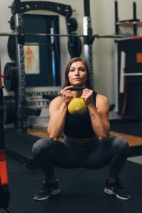 Fit Chick Performing Kettlebell Squat